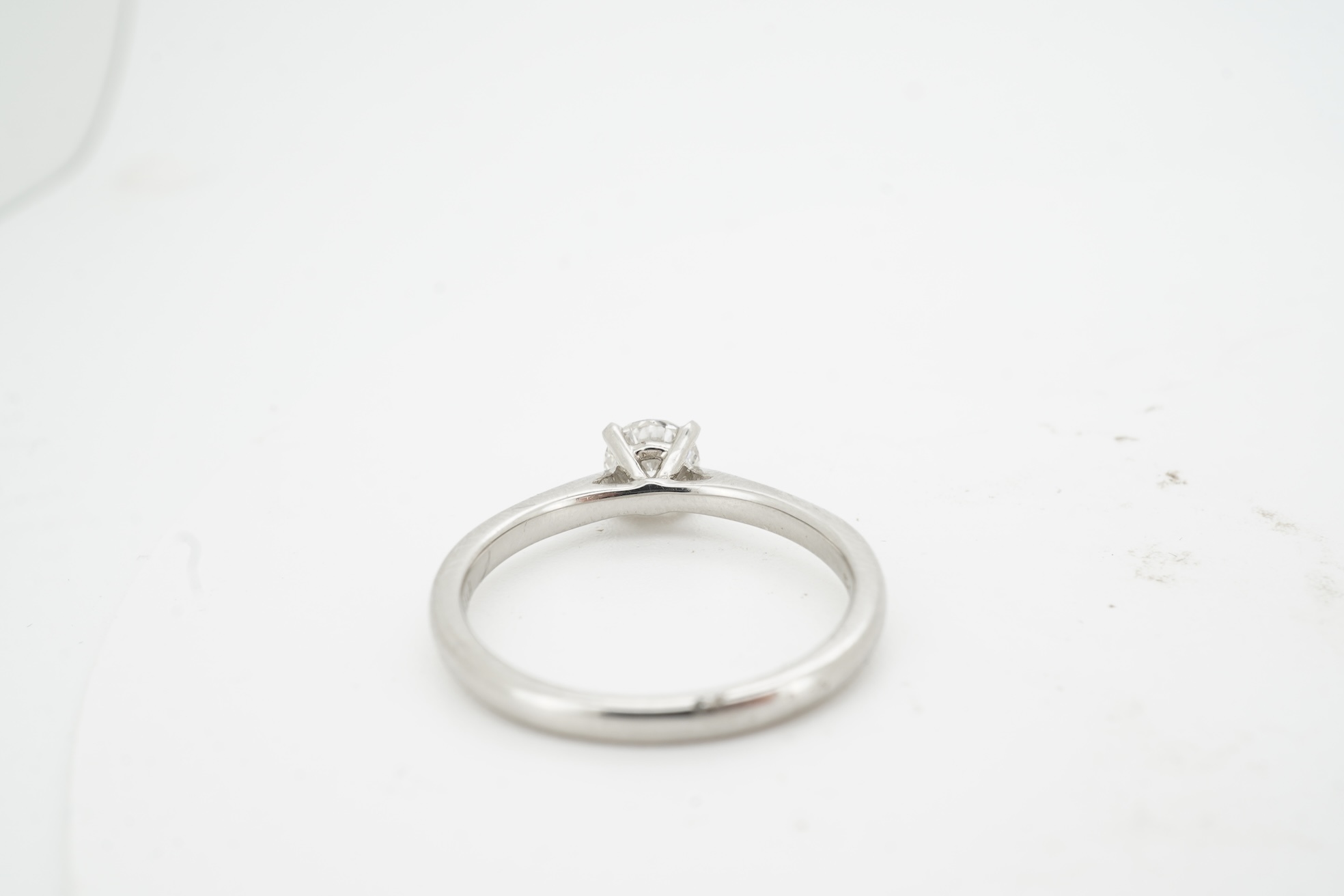 A diamond ring, claw-set with a brilliant-cut diamond weighing approximately 0.57 carats, mounted in platinum, size M, British hallmarks, gross weight approximately 3 grams